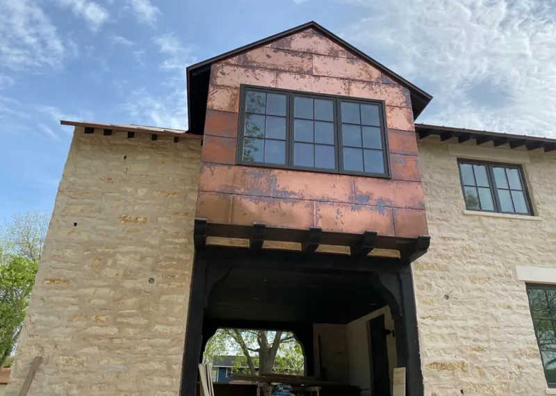 Copper metal panel facade on a stone building for Skylight Installation in Northdale